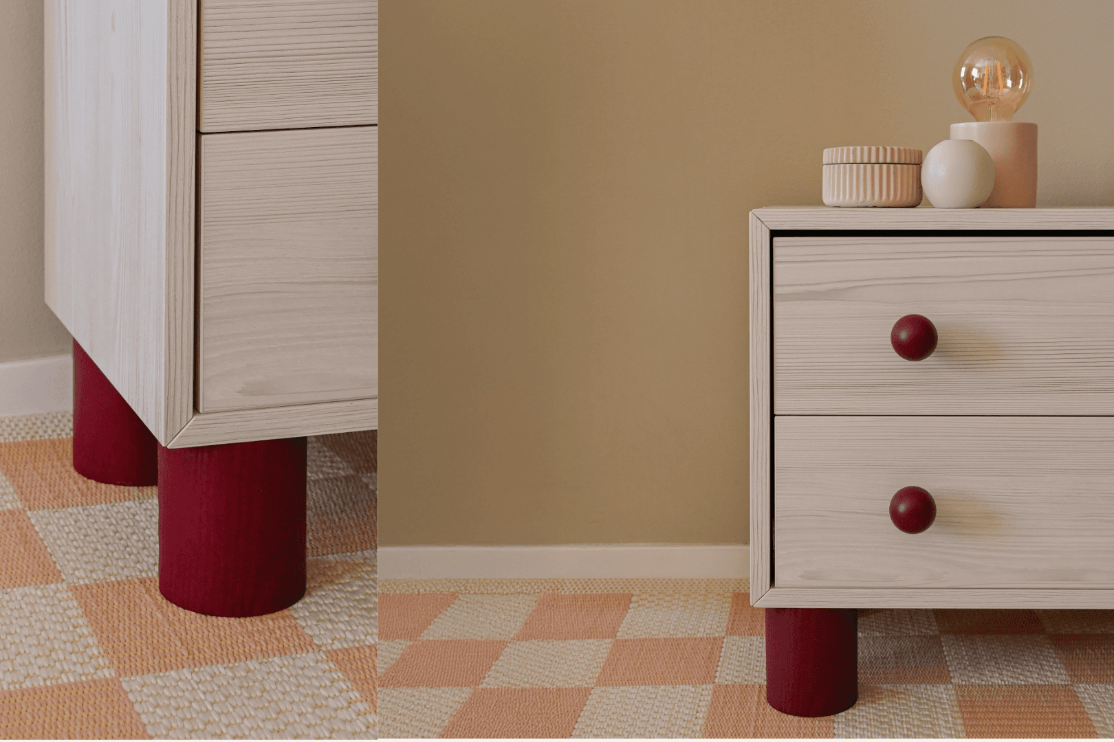 Table de chevet avec pieds cylindriques rouges et boutons assortis dans une pièce aux tons doux